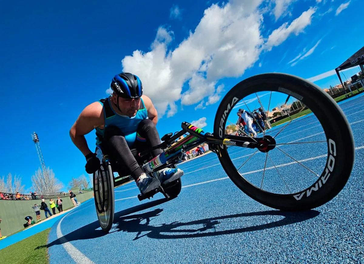 Persoa practicando handbike nunha pista azul.